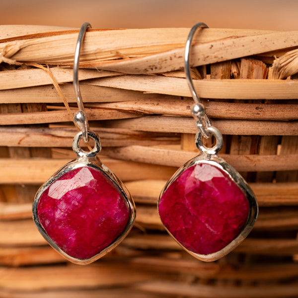 "Handcrafted sterling silver earrings with faceted ruby gemstones"