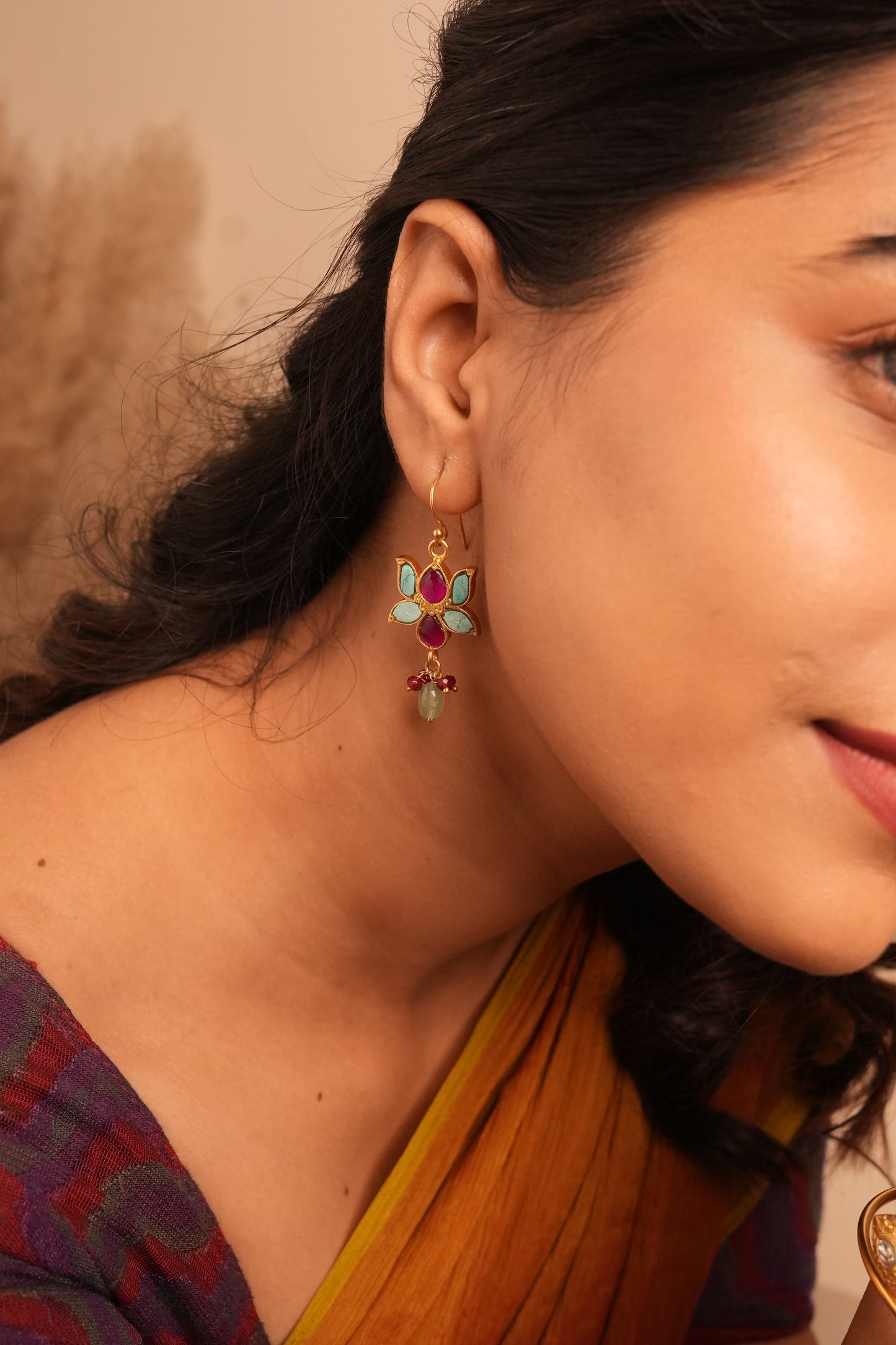 Gold-plated silver floral earrings with turquoise petals and ruby accents by Sil’alankaraa