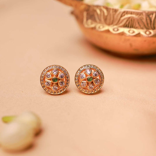 Gold plated floral halo stud earrings with crystal stones and green centre by Silalankaraa.