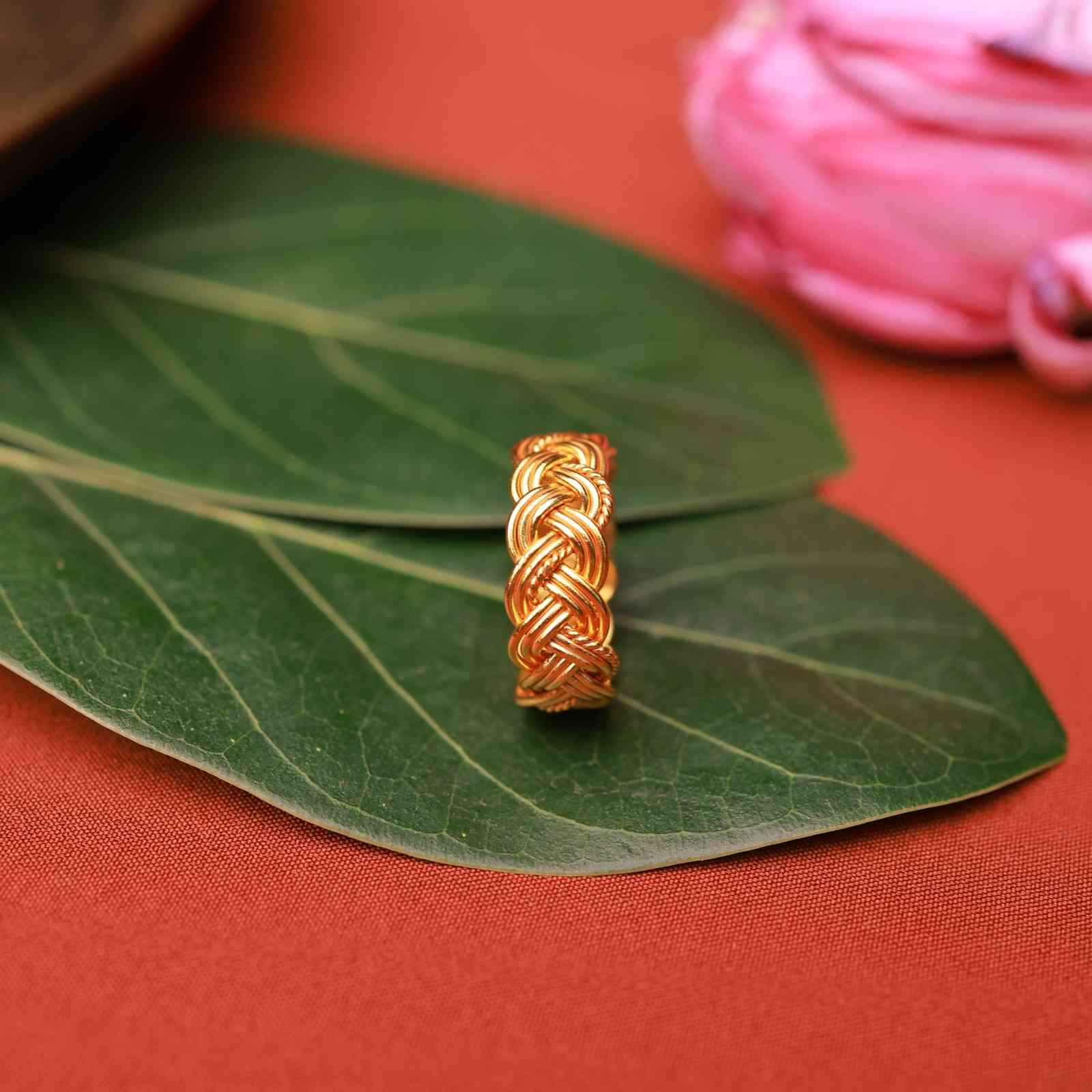 Gold plated braided knot ring with intricate woven design by Silalankaraa.