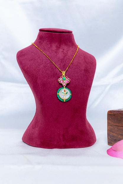 Gold-tone 92.5 silver necklace with a pink enamel lotus pendant, circular motif, and green stone detailing.