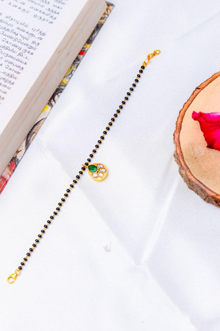 Silver Gold-Plated Mangalsutra Bracelet with Green Stone Pendant.