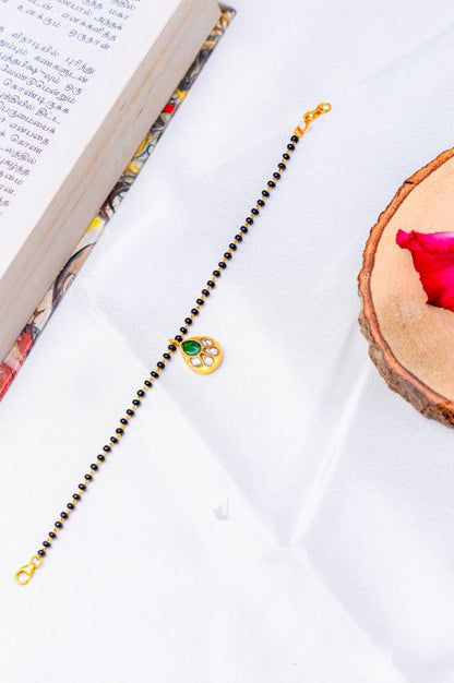 Silver Gold-Plated Mangalsutra Bracelet with Green Stone Pendant.