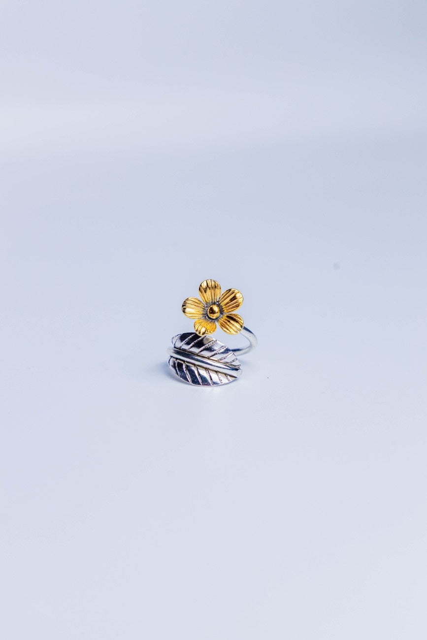 Dual-tone adjustable ring with a gold flower and silver leaf motif.