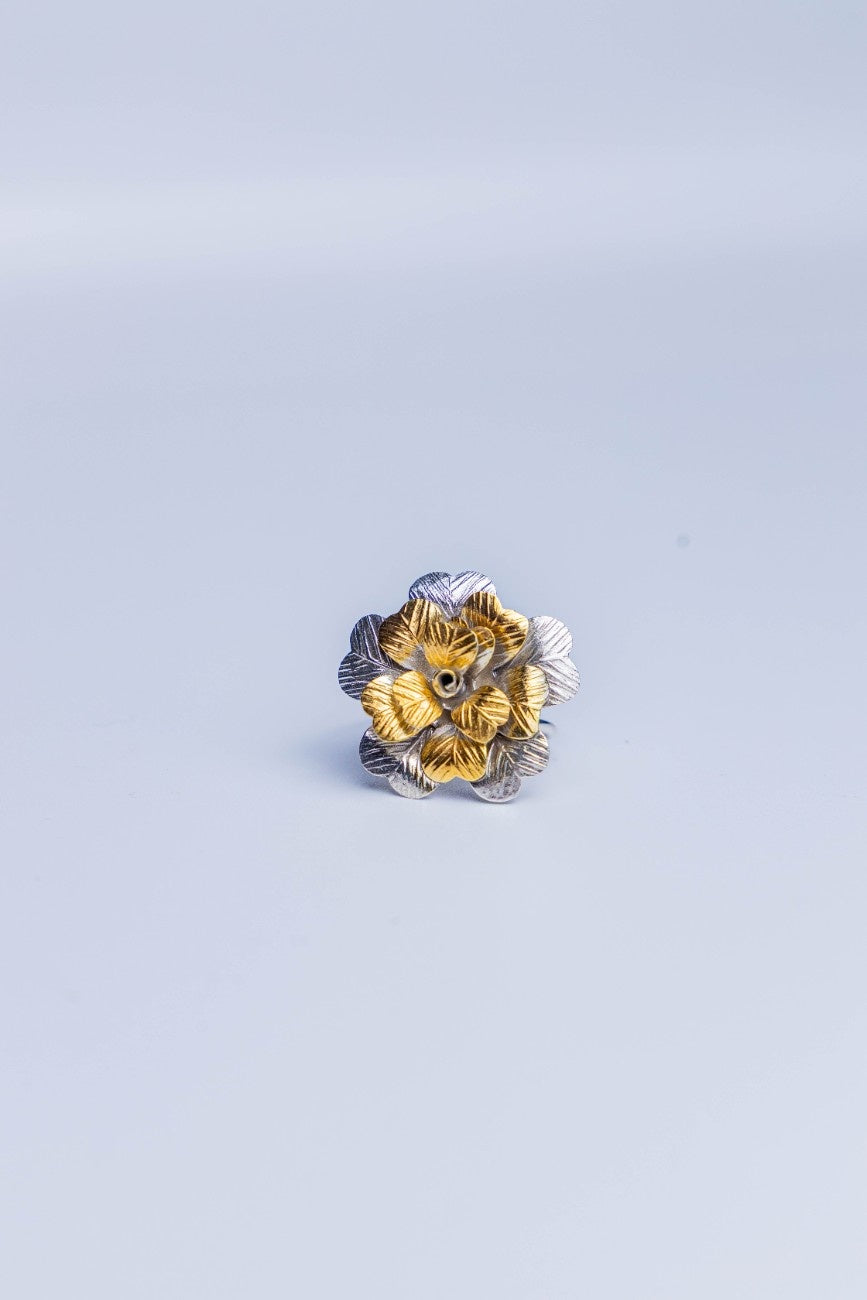 Dual-tone layered floral statement ring crafted in sterling silver with gold accents.