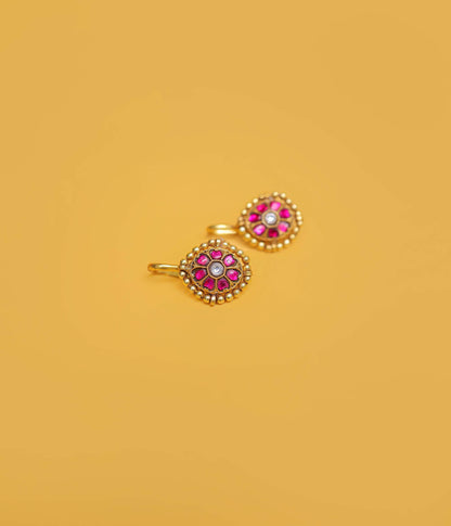 Ruby floral gold plated bugadi in 92.5 sterling silver with a beaded border and white centre stone.