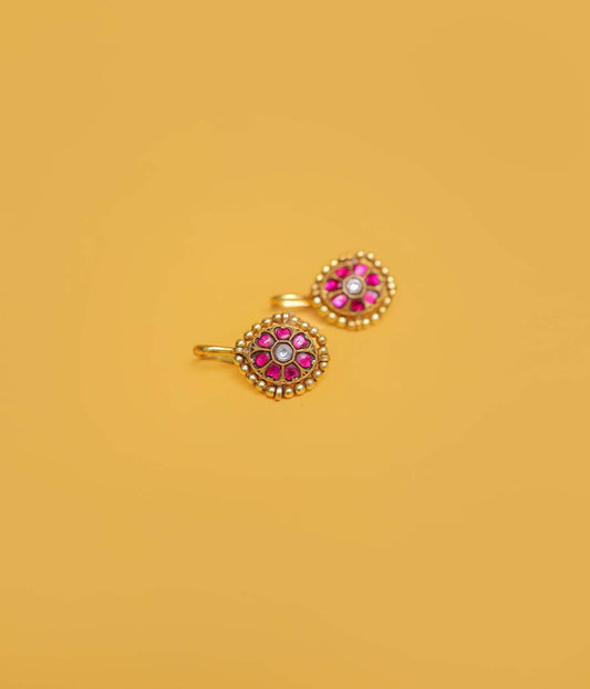 Ruby floral gold plated bugadi in 92.5 sterling silver with a beaded border and white centre stone.