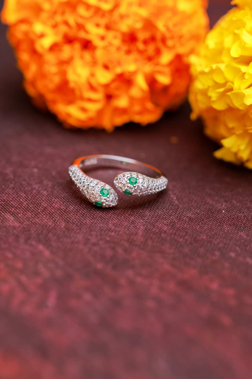 Silver Twin Serpent Ring with Green Stone Accents.