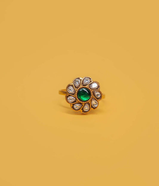 Emerald bloom gold plated ring in 92.5 sterling silver with green centre stone and white kundan floral design.