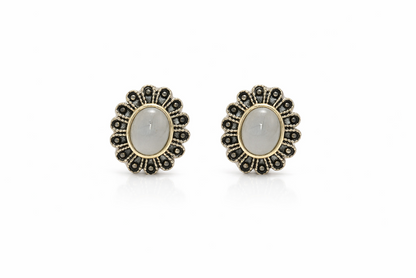 Pair of earrings with gemstones on a white background
