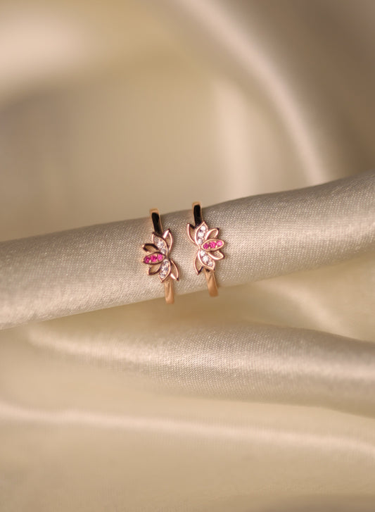 Rose gold toe rings with pink and white flower design.