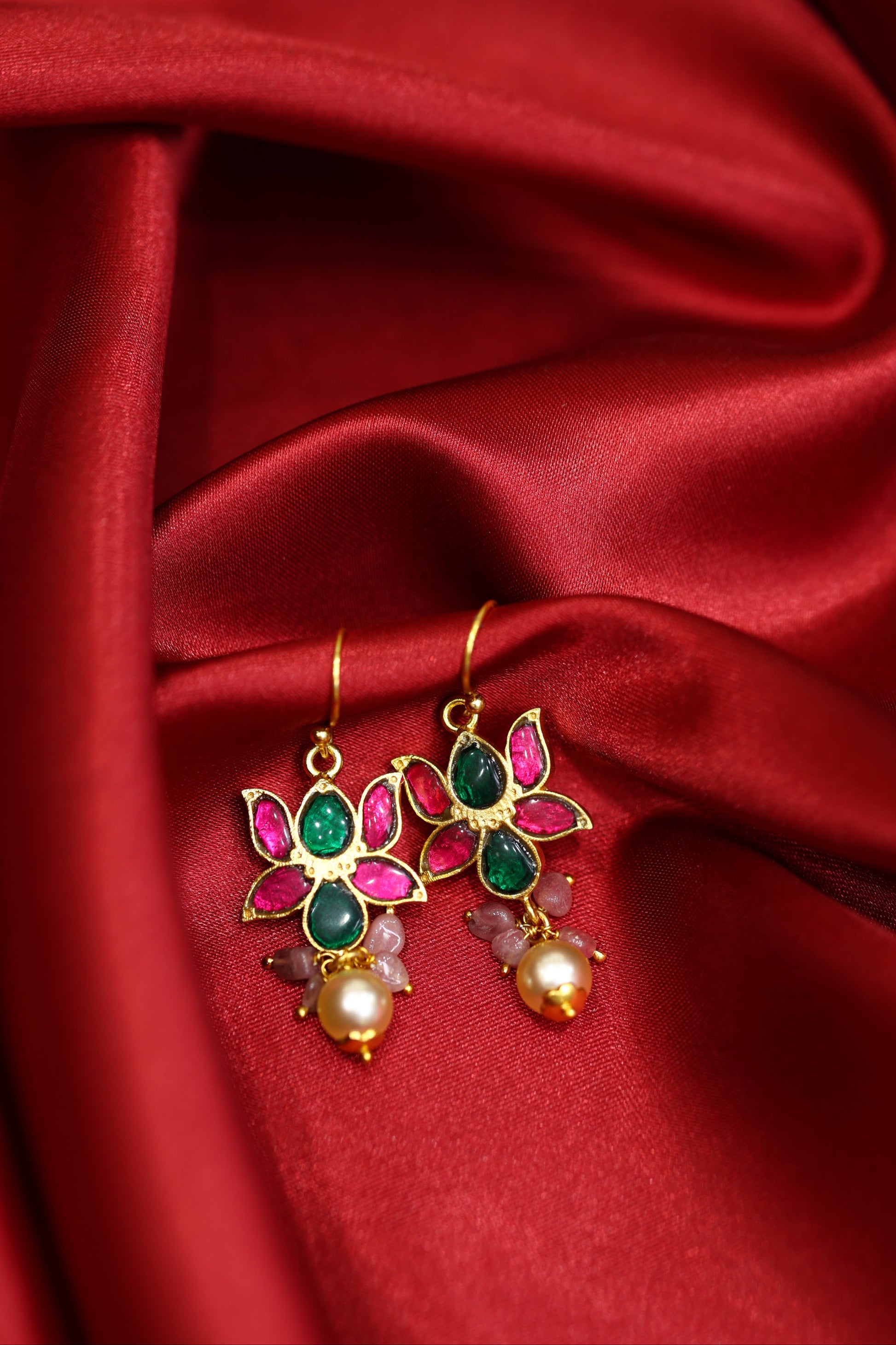 Handcrafted lotus motif gold-plated earrings with pink and green kundan stones and pearl drops