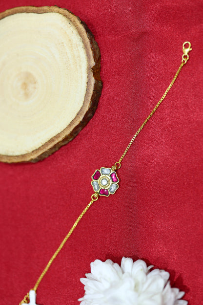 Gold-plated floral bracelet with pink and white petals.
