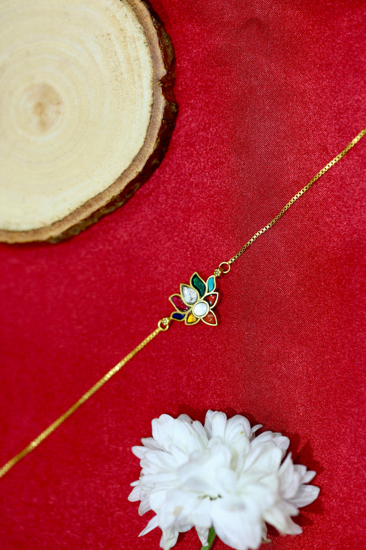 Gold-plated bracelet with a lotus charm made of multicolored petals and kundan stones.
