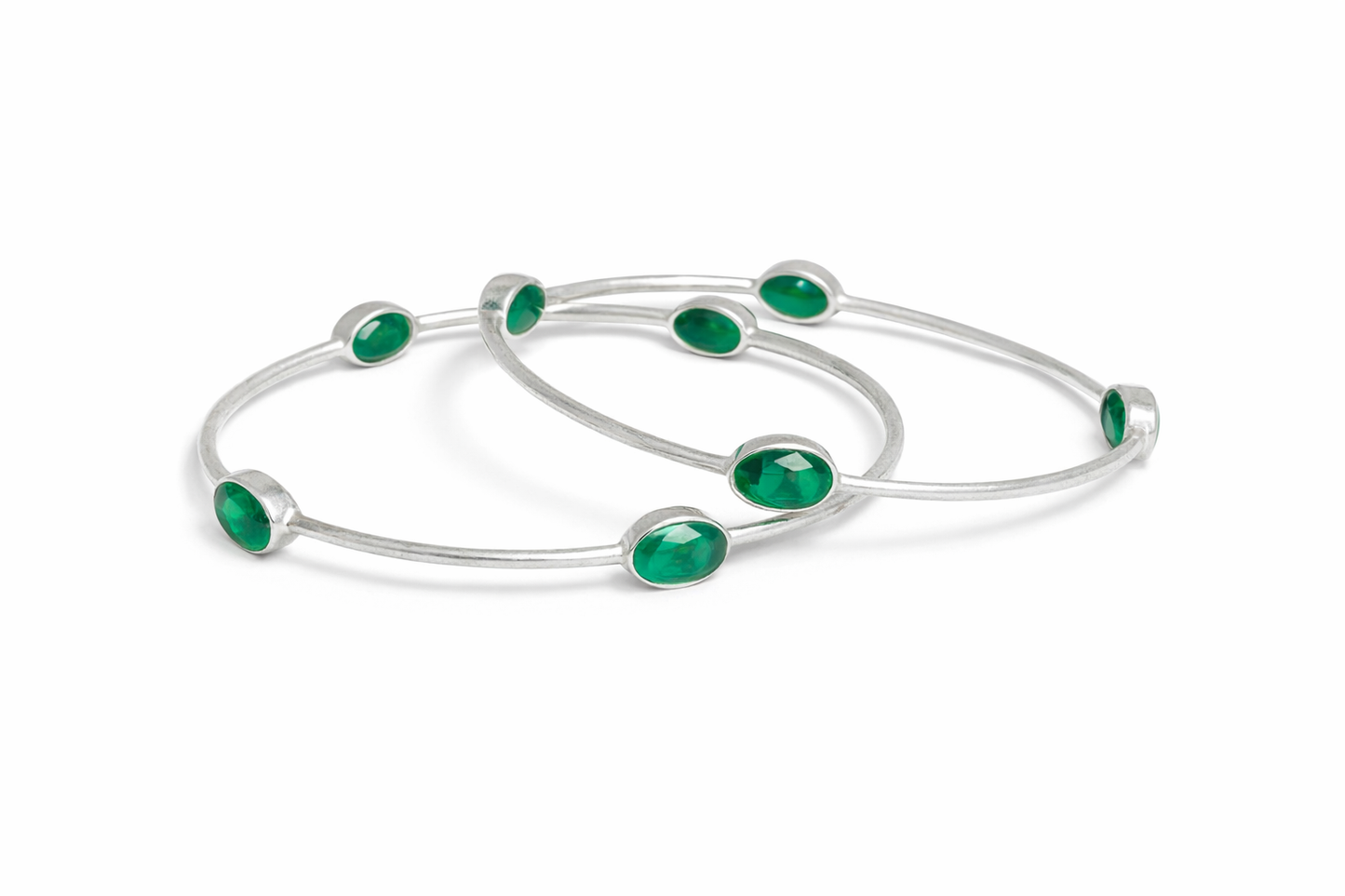 Sterling silver bangle with faceted emerald green stones.