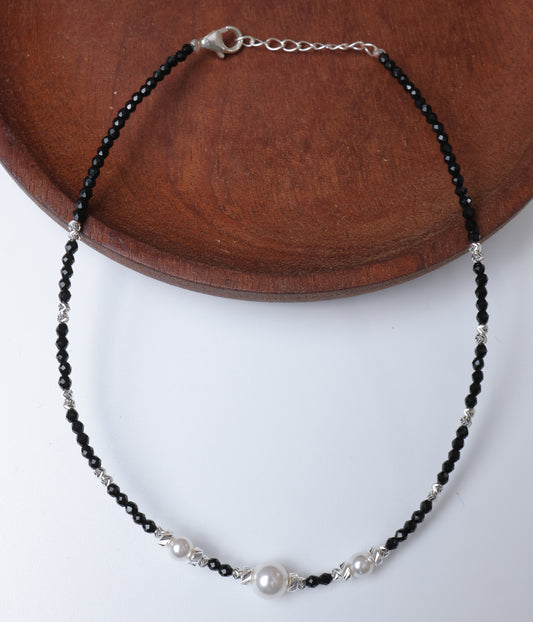 Black faceted beaded anklet with three white pearl accents and silver-tone decorative beads.