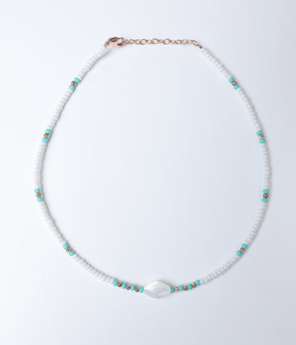 White pearl beaded anklet with turquoise accents, a white centrepiece bead and rose gold-tone detailing.