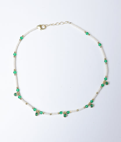 Green faceted stone and white pearl beaded anklet with gold-tone accents and green stone charms.