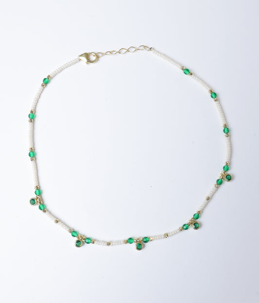 Green faceted stone and white pearl beaded anklet with gold-tone accents and green stone charms.